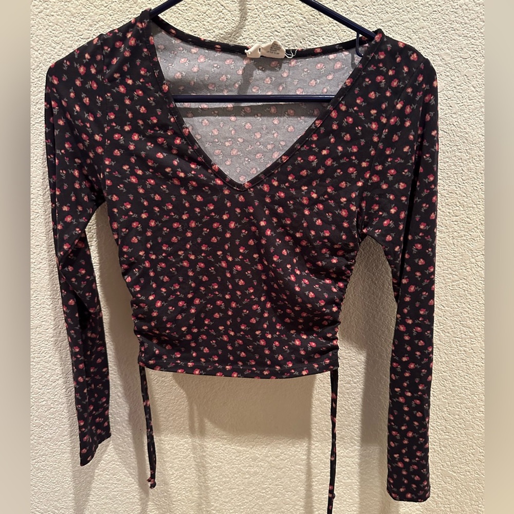 Black V-neck top with tiny red and pink roses.